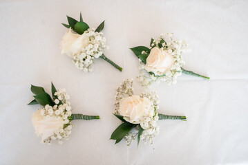 Four small roses as boutonnière