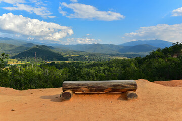 Obraz premium wooden stump chair with view of the mountains