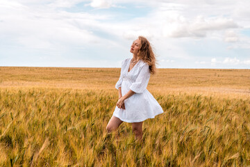 Russia, Republic of Tatarstan, Kalmash village, August 01, 2024, 17:00, girl in a dress in a wheat...
