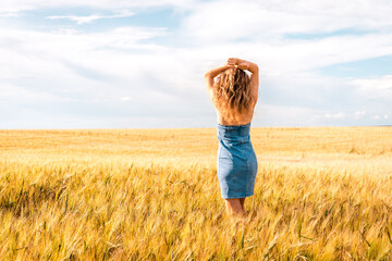 Russia, Republic of Tatarstan, Kalmash village, August 01, 2024, 17:00, girl in a dress in a wheat...