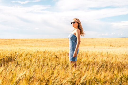 Russia, Republic of Tatarstan, Kalmash village, August 01, 2024, 17:00, girl in a dress in a wheat field in summer
