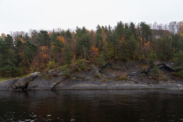 Fototapeta premium Oslo, Norway - October 20, 2024: Oslofjord (Oslofjorden), view of the bay and the island. Autumn forest