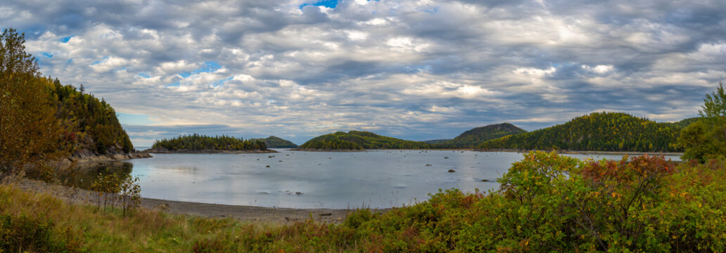 Panoramic view of a bay and beach with harbour and grey seals resting on rocky outcrops, Bic National Park (parc national du bic), Quebec, Canada