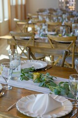 Elegant table setting with greenery centerpiece.