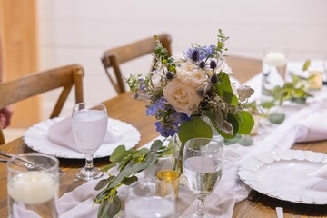 Elegant table setting with floral centerpiece.