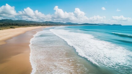 Tranquil vacation scene showcasing a stunning beach landscape with gentle waves and soft sand from a bird s eye perspective