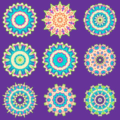 Set of beautiful colorful floral mandalas isolated on purple.