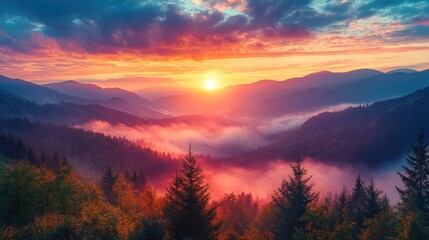 Obraz premium Vibrant sunrise over a misty mountain range with colorful clouds and a layer of fog creating a serene and picturesque landscape.