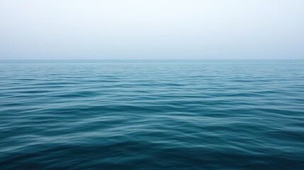 Obraz premium A serene, minimalist background with a gradient of blue shades, transitioning from deep ocean blue to light sky hues, creating a tranquil atmosphere.