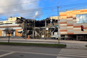 Fototapeta premium War in Ukraine, missile strike by Russians on shopping center, store, civilian building in Ukraine. Russians burned and destroyed building.