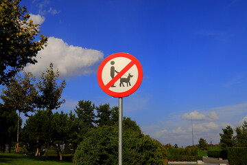No Dog Walking Sign, Dogs not allowed, Round Sign in Park