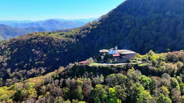 Stunning footage of Glozhene Monastery, perched on the edge of a rocky cliff in the foothills of the Balkan Mountains, filmed with a drone. Perfect for projects highlighting natural and historical lan