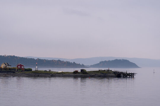 Oslo, Norway - October 20, 2024: Oslofjord (Oslofjorden), view of summer houses and cottages. Frame houses for recreation. Hut among the forest and rocks. Multicolored private houses.