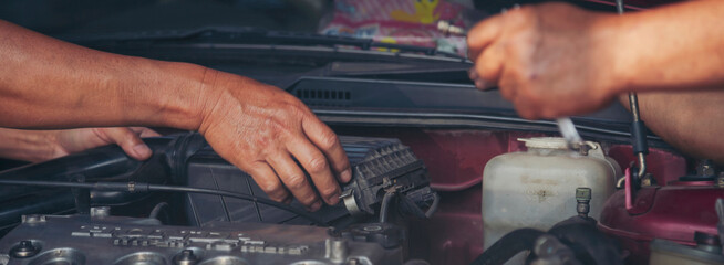 Banner Close up Mechanic man hands repairing car auto repair shop. Banner Man hands fixing machinery check vehicle mechanical motor service. Vehicle Car overhaul maintenance engineer with copy space