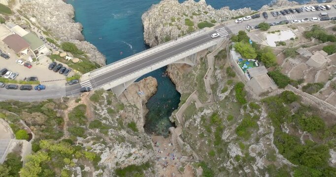 Aerial view of Ciolo's Bridge in the province of Lecce, Salento, Puglia, Italy. It is a single-span bridge and crosses a inlet. It overlooks the Mediterranean Sea.