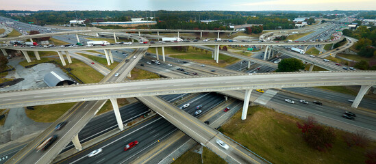 Aerial view of american freeway intersection with fast moving cars and trucks. USA transportation...