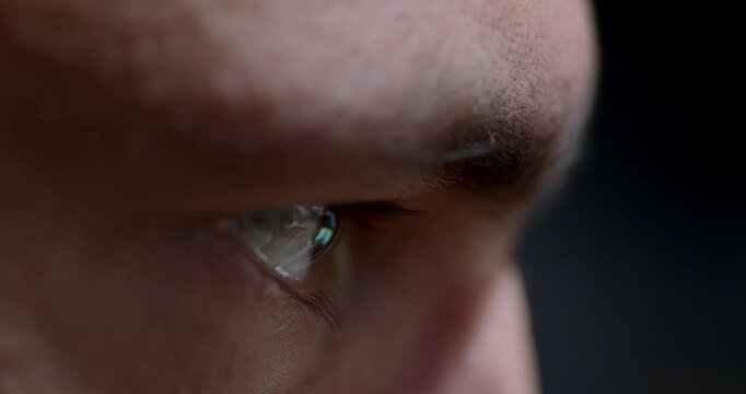 Detailed closeup view of eye beautifully illuminated by vivid screen reflections