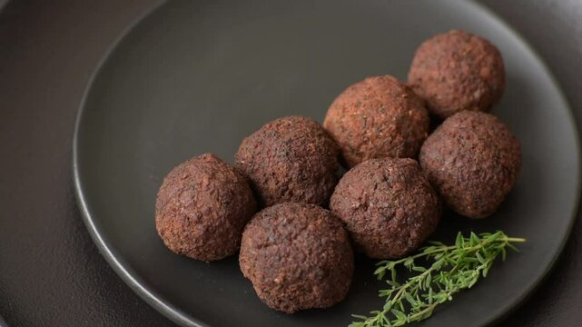 Falafel vegetarian and vegan dish made with chickpeas, spices and herbs on a dark concrete background