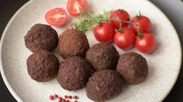 Falafel vegetarian and vegan dish made with chickpeas, spices and herbs on a dark concrete background