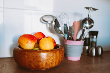 Kitchen utensils or cooking tools in iron decorative bucket, on kitchen wooden surface. Kitchen utensils collection