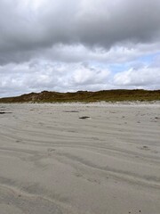 beach and sea with a hint of the rolling hills and sand dunes Ireland co Donegal