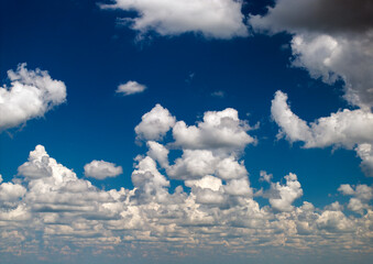 Bright landscape of blue sky with flying white clouds. Colorful summer skyscape