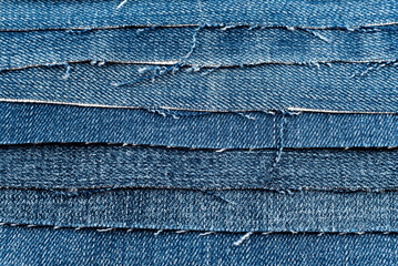 Texture from torn pieces of denim. Jeans texture. Material for sewing clothes