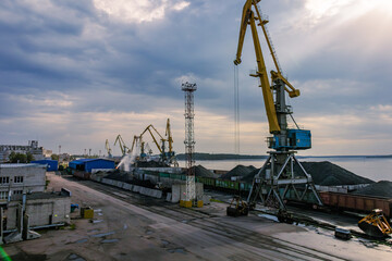 Cranes on the embankment. Unloading coal