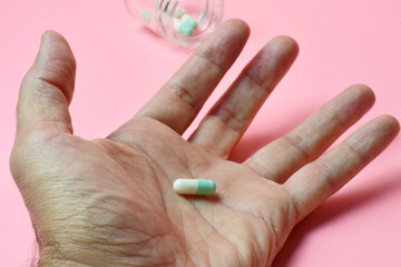 Concept of medication to heal, person with a pill in his hand.