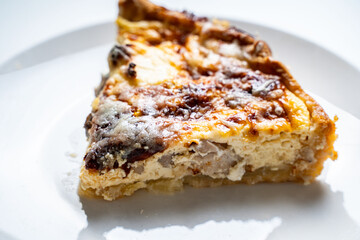 Traditional French pie. Quiche Loren on a white kitchen table.