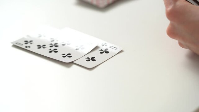 Close-up of a deck of cards on which the cards are placed and shuffled at the table. The concept of board card games, having fun, entertainment, poker, solitaire