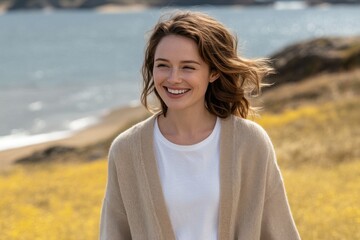Smiling woman on the beach with grassy dunes and warm sunset tones
