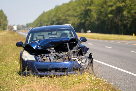 Fototapeta Dumped crashed car after traffic accident parked on highway roadside