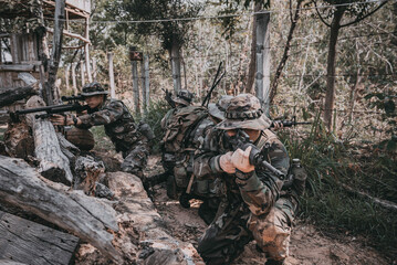 Team of army soldier with machine gun moving in the forest,Thai militia soldier in combat uniforms...