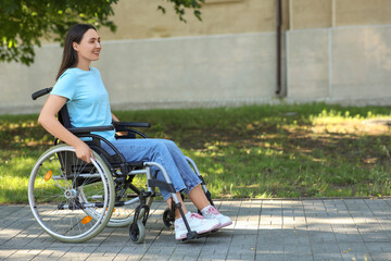 Young woman in wheelchair enjoying sunny days outdoors
