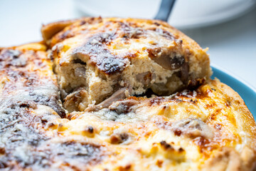 Traditional French pie. Quiche Loren on a white kitchen table.