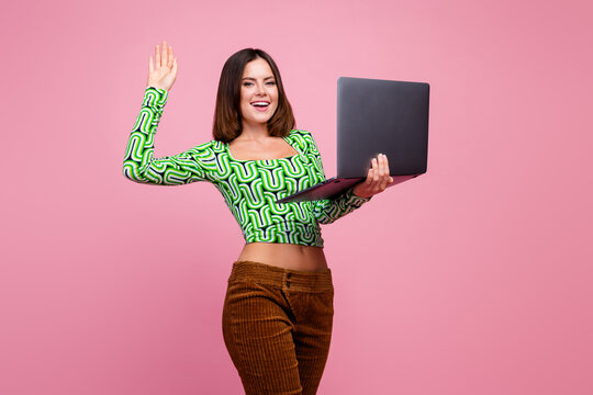 Photo of adorable cheerful woman wear green stylish clothes hold dadget isolated on pink color background