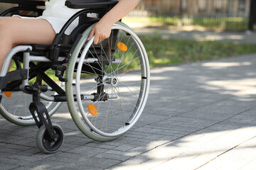 Fototapeta premium Woman in wheelchair outdoors, closeup