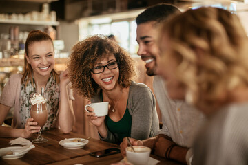 Group of young people enjoying a coffee in a cafe