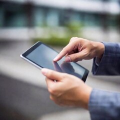 Extreme close up business man hands with tablet, ruck focus, blurred background