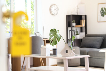 Open door of hotel room with door hanger