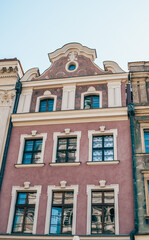 Colorful Historic Buildings and Houses on Stary Rynek Square in Poznań, Poland, with a Blue Sky...