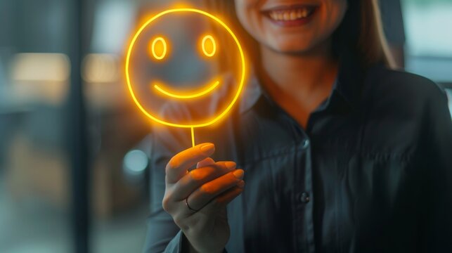 Woman Holding a Glowing Smiley Face Icon: Customer Satisfaction and Happiness