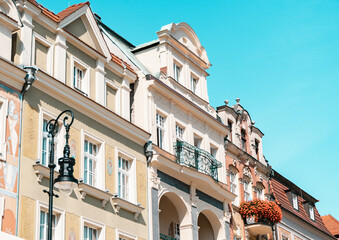 Colorful Historic Buildings and Houses on Stary Rynek Square in Poznań, Poland, with a Blue Sky...