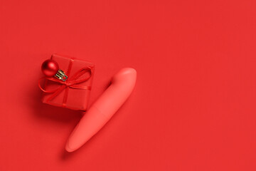 Vibrator and Christmas gift on red background