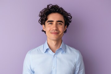 Fototapeta premium Confident Young Man in Light Blue Shirt on Lavender Background - Ideal for Portrait Design