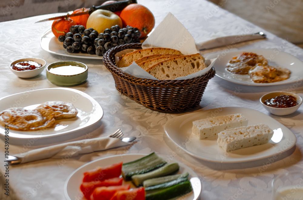 Wall mural a cozy breakfast spread featuring a mix of fresh fruits, sliced vegetables, bread, cheese, and panca