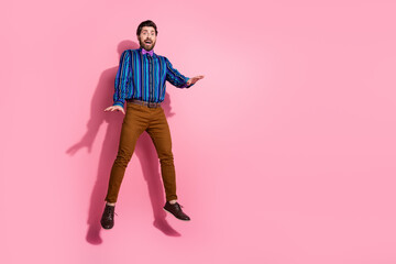 Full length photo of crazy cool funny man wear trendy clothes empty space isolated on pink color background