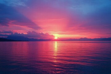 Naklejka premium A breathtaking sunset over calm waters creates a vibrant purple and pink sky in the evening