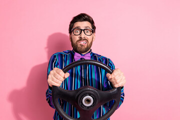Photo of crazy worried funny man wear stylish clothes drive car vehicle isolated on pink color background
